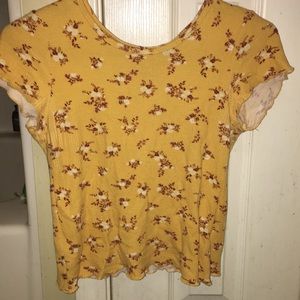 Yellow t-shirt with little flowers on it